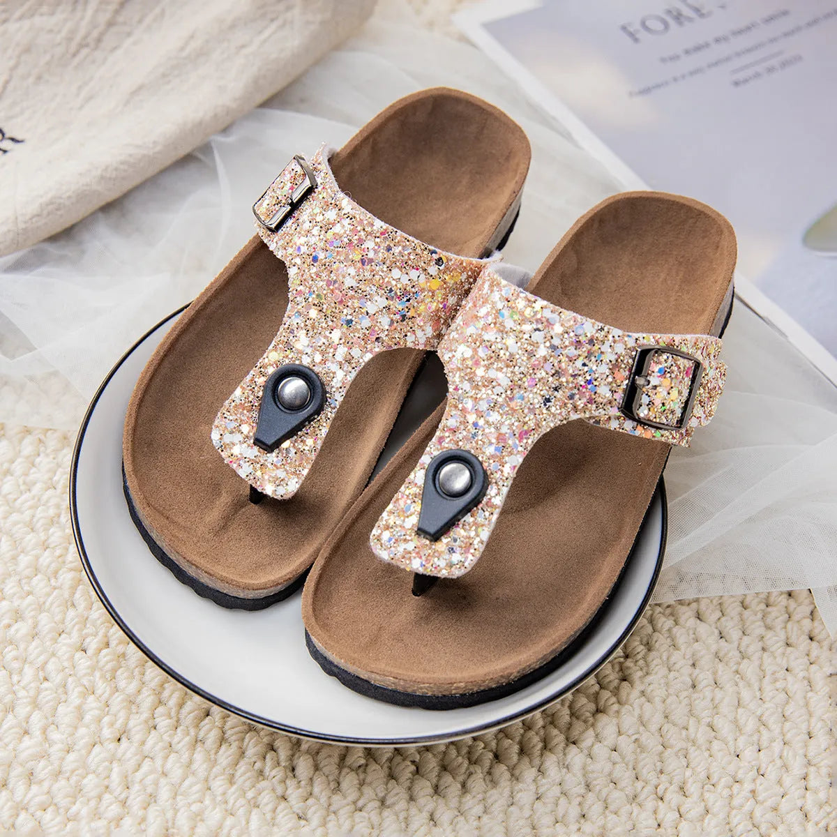 Gold, pink, and silver cork couples flip-flops with artificial leather upper and non-slip sole.