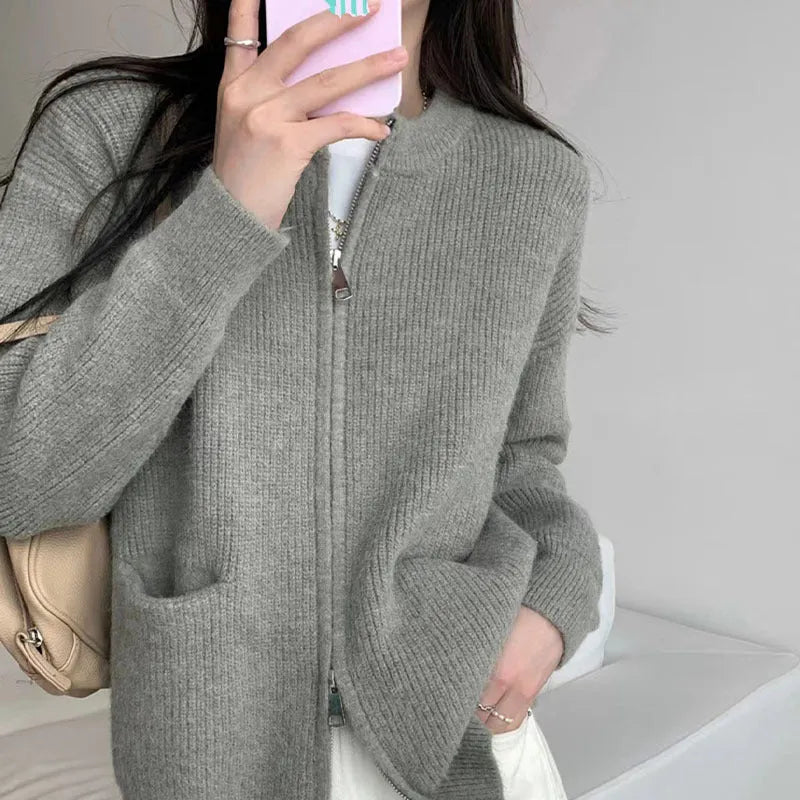Beige viscose knit cardigan coat with long sleeves on a hanger.
