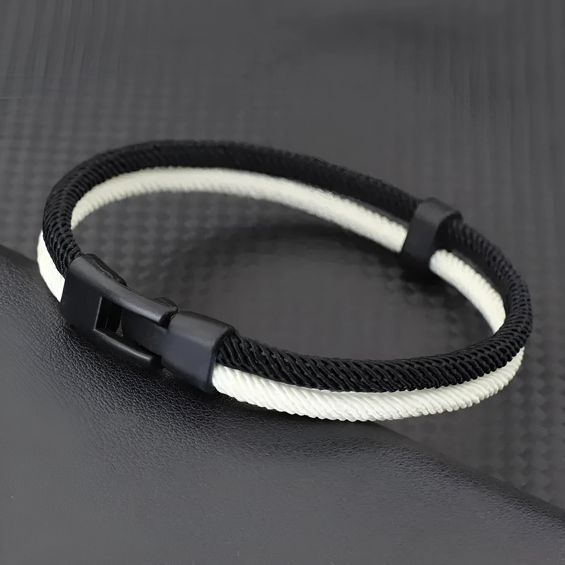 Handmade woven hand strap in Milan rope alloy showing black and white colour options and woven texture