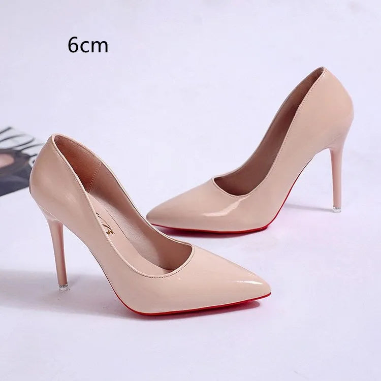 Women's black pointed toe stiletto heel pumps with a shallow mouth design on a plain background.